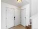 Clean entryway with tile flooring, coat hooks, and two white doors at 19804 E Villanova Pl, Aurora, CO 80013