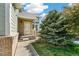 Inviting front entrance with brick accents and lush landscaping creating great curb appeal at 19804 E Villanova Pl, Aurora, CO 80013