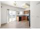 Bright kitchen features sliding glass door to a patio, black appliances, and wooden cabinets at 19804 E Villanova Pl, Aurora, CO 80013
