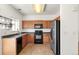 Efficient kitchen with wood cabinets, stainless steel appliances, and lots of counter space at 19804 E Villanova Pl, Aurora, CO 80013