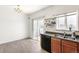 Eat-in kitchen with sliding glass door to a patio, black appliances, and wooden cabinets at 19804 E Villanova Pl, Aurora, CO 80013