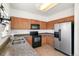 Well-lit kitchen boasts stainless steel refrigerator and ample counter space at 19804 E Villanova Pl, Aurora, CO 80013