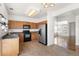 Spacious kitchen boasts stainless steel refrigerator and flows into a bright living area at 19804 E Villanova Pl, Aurora, CO 80013