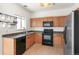 Functional kitchen with wood cabinets, stainless steel refrigerator, and modern appliances at 19804 E Villanova Pl, Aurora, CO 80013