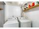 Laundry room with washer, dryer, and storage space at 19804 E Villanova Pl, Aurora, CO 80013