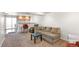 Comfortable living room with plush carpet, cozy seating, and a bar area with cabinets at 19804 E Villanova Pl, Aurora, CO 80013