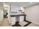 Finished basement bar featuring white cabinets, dark countertops and flooring, and a beverage refrigerator at 4728 S Acoma St, Englewood, CO 80110