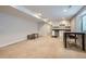 Finished basement area with neutral carpet, updated lighting, and a bar area for entertaining at 4728 S Acoma St, Englewood, CO 80110