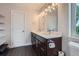 Bathroom with double vanity sinks, dark wood cabinets and tiled floors at 4728 S Acoma St, Englewood, CO 80110