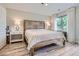 Primary bedroom with a uniquely carved wood bed frame and bright natural light at 4728 S Acoma St, Englewood, CO 80110