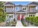 Inviting townhome exterior with red doors, balconies, and a well-maintained front yard at 4728 S Acoma St, Englewood, CO 80110