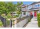 Charming home featuring a landscaped front yard with a black metal fence and walkway at 4728 S Acoma St, Englewood, CO 80110