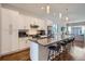 Modern kitchen featuring white cabinets, stainless steel appliances, and an eat-in island at 4728 S Acoma St, Englewood, CO 80110