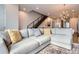 Inviting living room area with a large sectional sofa, decorative pillows, and a modern staircase at 4728 S Acoma St, Englewood, CO 80110