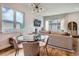 Cozy living space with a round glass table, comfortable seating, and bright natural lighting at 4728 S Acoma St, Englewood, CO 80110