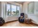 Bright sitting area with hardwood floors, large window with neighborhood views and a massage chair at 4728 S Acoma St, Englewood, CO 80110