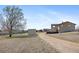 Wide backyard featuring a container and mature tree offering shade and privacy at 59 S De Gaulle St, Aurora, CO 80018