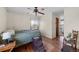 Bright bedroom featuring hardwood floors, a window with scenic views, and plenty of natural light at 59 S De Gaulle St, Aurora, CO 80018