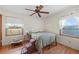 Well lit bedroom with hardwood floors and two windows offering picturesque landscape views of horse property at 59 S De Gaulle St, Aurora, CO 80018