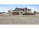Two-story home with a deck, stairs, and attached garage for convenient parking and outdoor enjoyment at 59 S De Gaulle St, Aurora, CO 80018