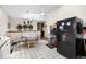 Bright kitchen/dining area features updated appliances, tile flooring, and ample counter space at 59 S De Gaulle St, Aurora, CO 80018
