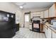 Functional kitchen with white cabinetry, essential appliances, and a practical layout at 59 S De Gaulle St, Aurora, CO 80018