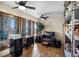 Bright home office with a cozy leather chair, tile floors, and ample storage shelves at 59 S De Gaulle St, Aurora, CO 80018