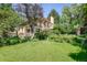 Lush backyard with mature trees, a spacious lawn, and beautiful landscaping at 199 Lafayette St, Denver, CO 80218