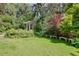 Lush backyard features mature trees, a pergola and a seating area to enjoy the view at 199 Lafayette St, Denver, CO 80218