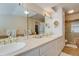 Elegant bathroom featuring double sinks, a soaking tub, and gold fixtures at 199 Lafayette St, Denver, CO 80218