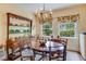 Charming dining room featuring a vintage hutch, chandelier, hardwood floors, and natural light at 199 Lafayette St, Denver, CO 80218