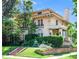 Stunning two-story home featuring a terracotta roof, manicured lawn, and beautiful landscaping at 199 Lafayette St, Denver, CO 80218