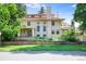 Elegant home with a red tile roof, classic architecture, and a well-maintained front lawn and brick retaining wall at 199 Lafayette St, Denver, CO 80218