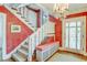 Inviting foyer with staircase, decorative chandelier, hardwood floors, and artistic walls, creating a grand entrance at 199 Lafayette St, Denver, CO 80218