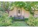 Peaceful garden with a decorative wall fountain, mature trees, and lush greenery, creating a serene and private oasis at 199 Lafayette St, Denver, CO 80218