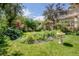 Serene garden with vibrant flowers, lush greenery, and a charming bird bath centerpiece at 199 Lafayette St, Denver, CO 80218
