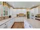 Spacious kitchen featuring granite countertops, white cabinetry, stainless steel appliances, and hardwood floors at 199 Lafayette St, Denver, CO 80218