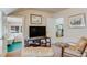 Cozy living room featuring a TV, artwork, a leather chair, and a glimpse into an adjacent bath, creating a relaxing space at 199 Lafayette St, Denver, CO 80218