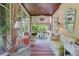 Light-filled sunroom boasting vintage furniture, striped rug, wood ceiling, and natural views at 199 Lafayette St, Denver, CO 80218