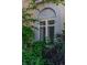 Arched window featuring decorative accents, surrounded by lush greenery, adding a touch of architectural detail and charm at 199 Lafayette St, Denver, CO 80218