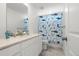 Bright bathroom with shower featuring a shark themed shower curtain, white vanity, and sink at 656 N Bersshine St, Watkins, CO 80137