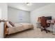 Neutral guest room featuring a single bed, desk, and comfy chair bathed in natural light at 656 N Bersshine St, Watkins, CO 80137