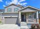 Charming two-story home with gray siding, stone accents, and a covered front porch at 656 N Bersshine St, Watkins, CO 80137