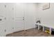 Practical mudroom with wood-look flooring, a bench, storage shelves, and a door to the outside at 656 N Bersshine St, Watkins, CO 80137