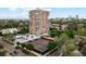 Aerial view of high-rise apartment building with tennis court and parking lot in an urban setting at 130 N Pearl St # 1103, Denver, CO 80203