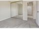 Bedroom featuring soft gray carpet and a mirrored closet at 130 N Pearl St # 1103, Denver, CO 80203