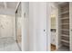 Hallway view with a mirror closet and an open door to the bathroom and storage at 130 N Pearl St # 1103, Denver, CO 80203