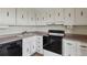 This kitchen is equipped with sleek black appliances, and light-colored cabinets at 130 N Pearl St # 1103, Denver, CO 80203