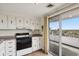 Bright kitchen featuring white cabinetry and a sliding glass door to a balcony with city views at 130 N Pearl St # 1103, Denver, CO 80203