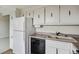 Bright kitchen showcasing white cabinets, modern appliances, and efficient layout for a seamless cooking experience at 130 N Pearl St # 1103, Denver, CO 80203